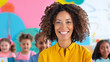 © Luluraschi - a smiling black female teacher in a colorful classroom, surrounded by attentive elementary students