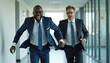 © Cad3D.Expert - Two male business professionals in suits running joyfully through a bright office hallway, exuding confidence, teamwork, and energy in a modern corporate setting.