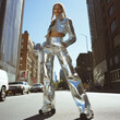 © Anna K@S - Fashionable woman in metallic outfit posing confidently in urban cityscape