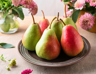 green and red ripe juicy pears on plate with flowers in glass vasess