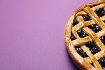 Poster - Tasty homemade pie with blueberries on purple table, closeup. Space for text