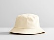 © WE.ARE.AI - 3D render of a blank beige bucket hat on a smooth grey surface, highlighting fabric texture and simplicity