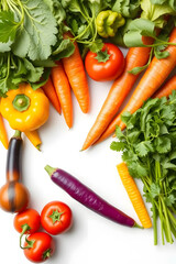 Wall Mural - A vibrant assortment of fresh vegetables including carrots, tomatoes, bell peppers, leafy greens, and herbs arranged artistically on a white background.