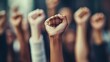 © TAHIYA - Raised fists in solidarity during a protest with blurred crowd in the background