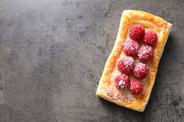 Poster - Tasty puff pastry with raspberries on grey table, top view. Space for text