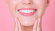 © Andres Mejia - Woman smiling showing healthy white teeth on pink background