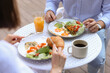 © New Africa - Couple having tasty breakfast in outdoor cafe, closeup