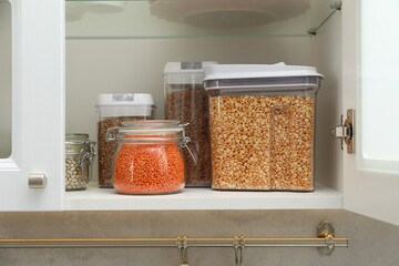 Wall Mural - Different types of cereals and legumes in containers in closet