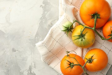 Poster - Branch of yellow tomatoes on grey textured table, top view. Space for text