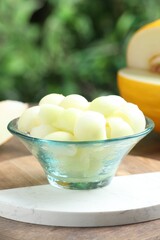 Fresh ripe melon balls in dessert bowl on table outdoors, closeup