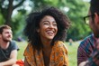 © Dina - diverse group of friends sharing a joyful moment, smiling and laughing together at a park picnic, highlighting the power of positive interactions and connections