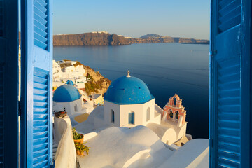 Canvas Print - traditional greek village Oia of Santorini, narrow street with blue domes against sea and caldera, Santorini Greece, close up view