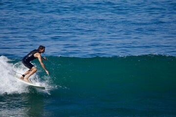 man catching a wave with his surfboard