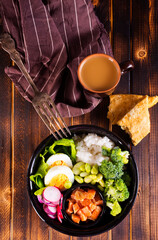 Wall Mural - Rice with red fish, green beans and broccoli in a black plate. Diet.