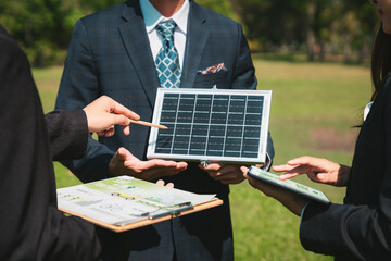 Wall Mural - Outdoor business meeting on solar energy, group of business people working and brainstorming on alternative energy technology utilization as corporate commitment to CSR effort. Gyre