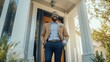 © fotofabrika - A smiling man in a blazer stands confidently on his front porch during the morning sunshine, showcasing a warm and welcoming atmosphere