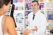 © JackF - Man pharmacist near cash register area serves customer, answers questions, and advises patient. Interaction between pharmacy employee and visitors, offline trade in cosmetics and medicinal products