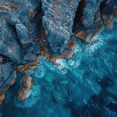 Poster - Aerial View of Ocean Waves Crashing Against Rugged Cliffs