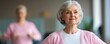 © Anny - Senior woman participating in a light exercise session with her caregiver, encouraging and supportive care