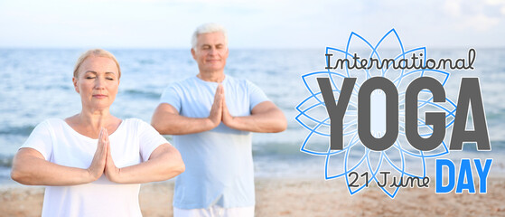 Wall Mural - Mature couple practicing yoga at sea resort