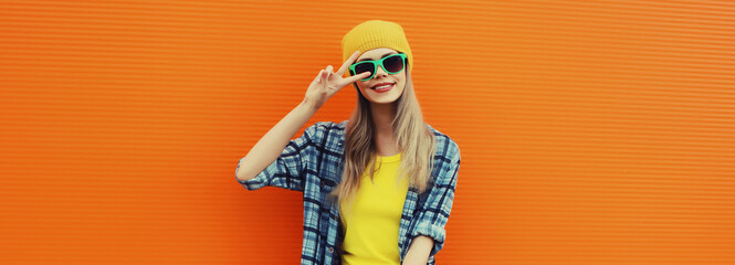 Summer portrait of happy stylish young woman, cheerful teenage girl in colorful clothes in the city