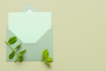 Wall Mural - Envelope with blank card and plant branches on color background