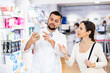 © JackF - Male pharmacist consulting woman buyer about drug in drugstore.