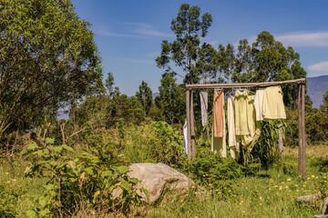 Some laundry sun drying hanging in a the garden of a farm, in a clear blue morning, near the colonial town of Villa de Leyva in central Colombia.