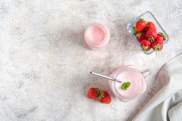 Wall Mural - Mason jar of tasty strawberry smoothie on light background