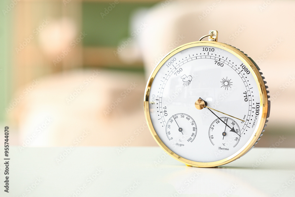 Aneroid barometer on white table in room, closeup