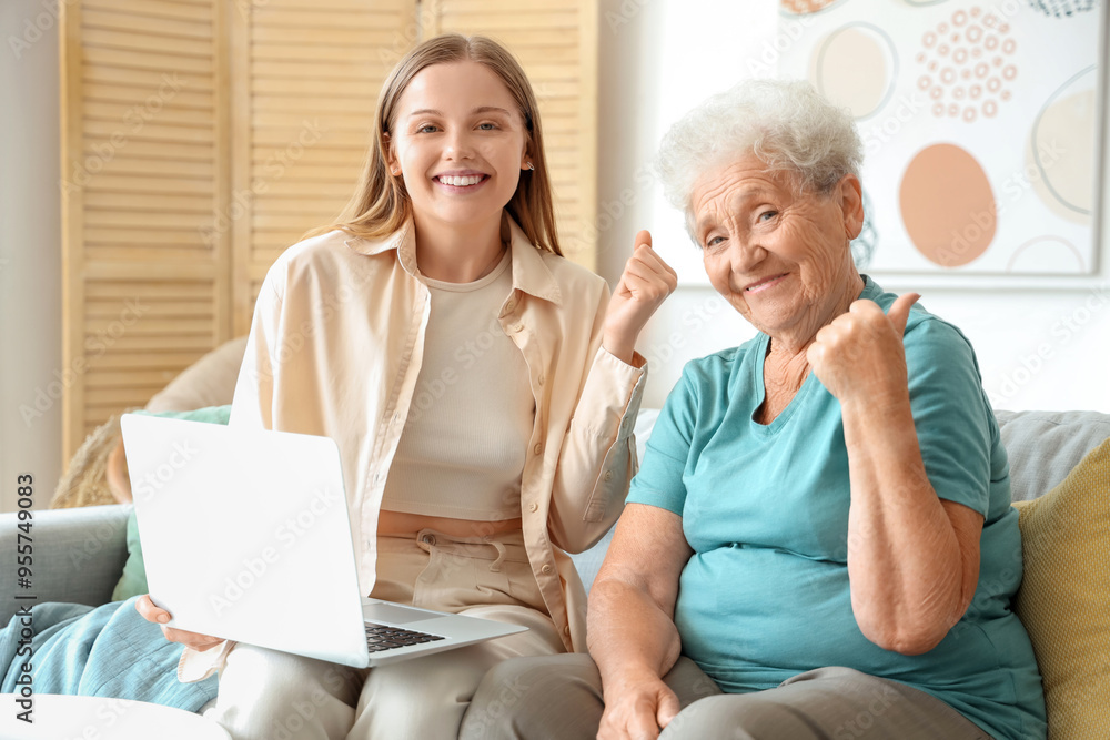 Senior woman with her granddaughter using laptop at home