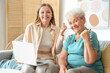 © Pixel-Shot - Senior woman with her granddaughter using laptop at home