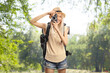 © Ljupco Smokovski - Female tourist with a backpack taking a photo with a camera