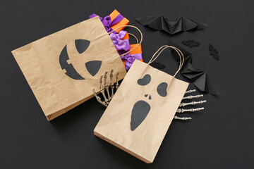 Sticker - Composition with paper shopping bags, gifts and decor for Halloween on dark background