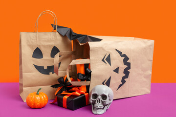 Poster - Composition with shopping bags, gifts and decor for Halloween on color background