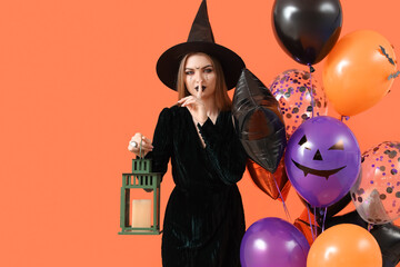 Sticker - Young woman dressed for Halloween as witch with lantern and balloons showing silence gesture on orange background