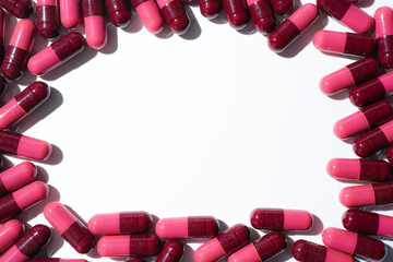 Wall Mural - Pills, red medical capsules, antibiotic vitamins on a white background