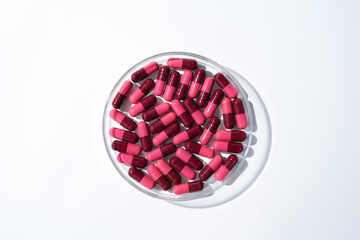 Wall Mural - red medical capsules, Pills antibiotic vitamins on a white background