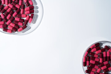 Wall Mural - red medical capsules, Pills antibiotic vitamins on a white background