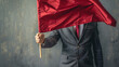 © Ali - a businessman holding a red flag