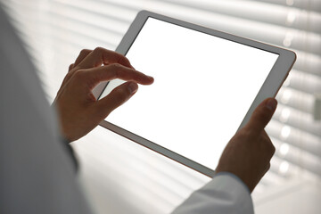 Wall Mural - Doctor using tablet in hospital, closeup view