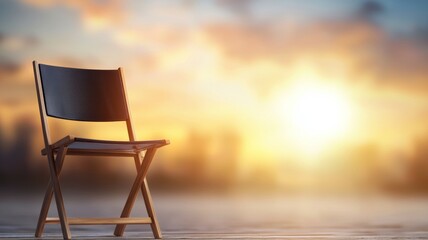 A wooden chair is sitting in front of a beautiful sunset