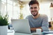 © kitipol - High-resolution brightly lit photorealistic candid photograph of a young marketer working happily on his laptop in a bright, modern office. The photograph is styled like a high-end lifestyle