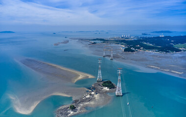 Wall Mural - Aerial view of transmission towers with high voltage lines on uninhabited islands against a thermal power plant at Yeongheungdo Island near Ongjin-gun, South Korea