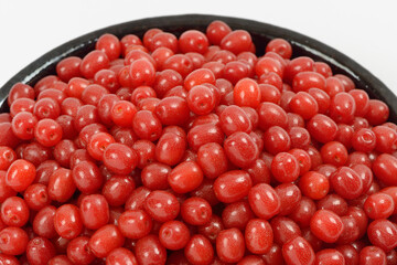 Wall Mural - Close-up of stacked red oleaster(Elaeagnus typica) fruits on ceramic bowl on white floor, South Korea