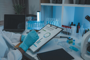 Wall Mural - a scientist is reviewing lab results and documents receives from researchers involved in chemical te
