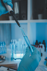 Wall Mural - a researcher is conducting scientific experiments on a liquid substance, a scientist is using labora
