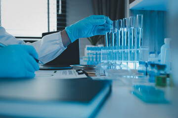 Wall Mural - a researcher is conducting scientific experiments on a liquid substance, a scientist is using labora