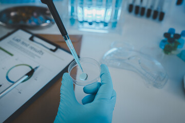 Wall Mural - a researcher is conducting scientific experiments on a liquid substance, a scientist is using labora
