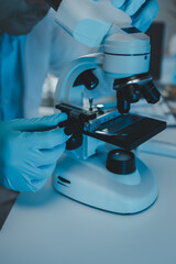 Wall Mural - a scientist uses a microscope to look for contaminants in a test sample, a researcher uses a microsc